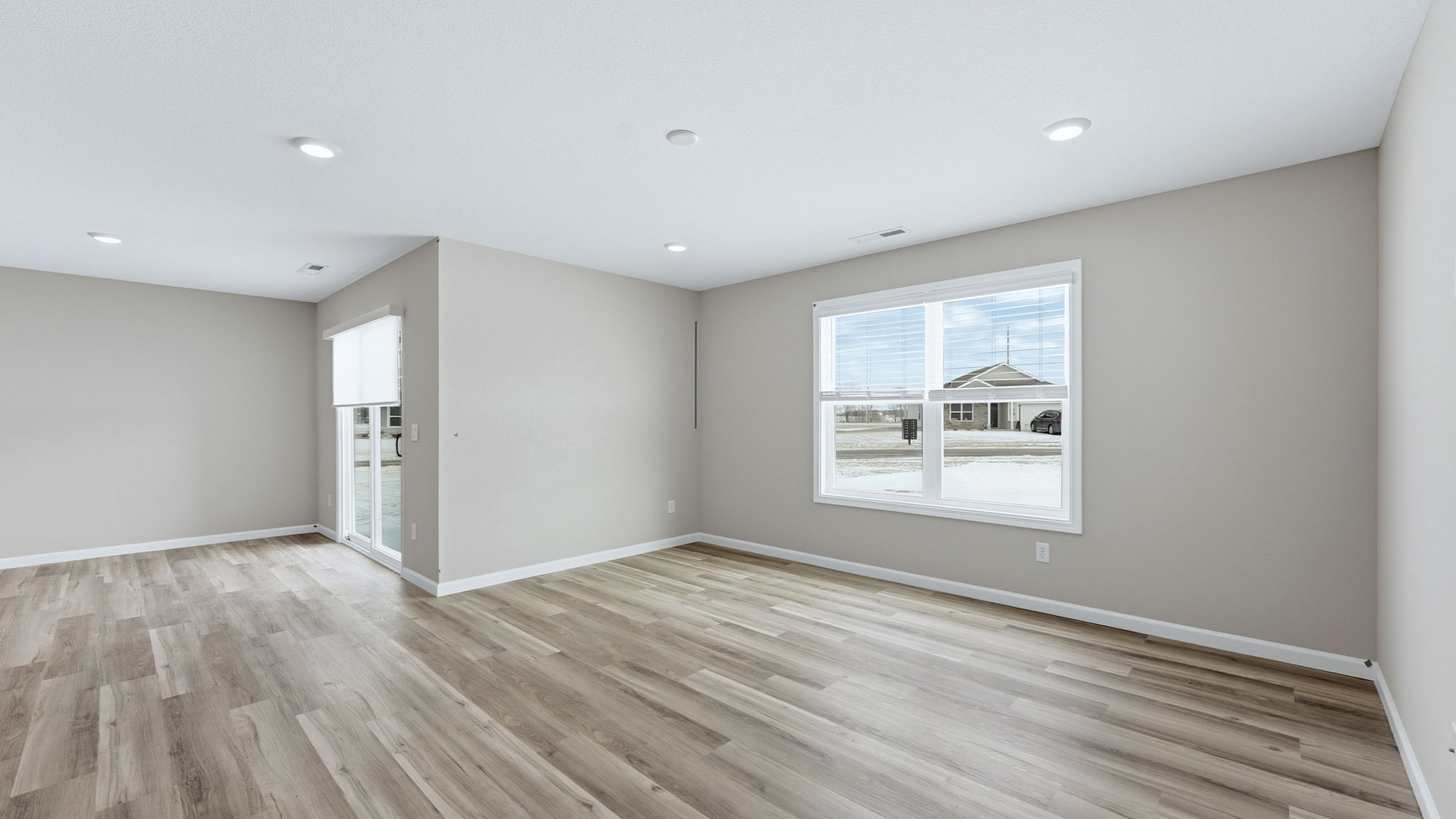 open layout living room with lvp flooring and large windows