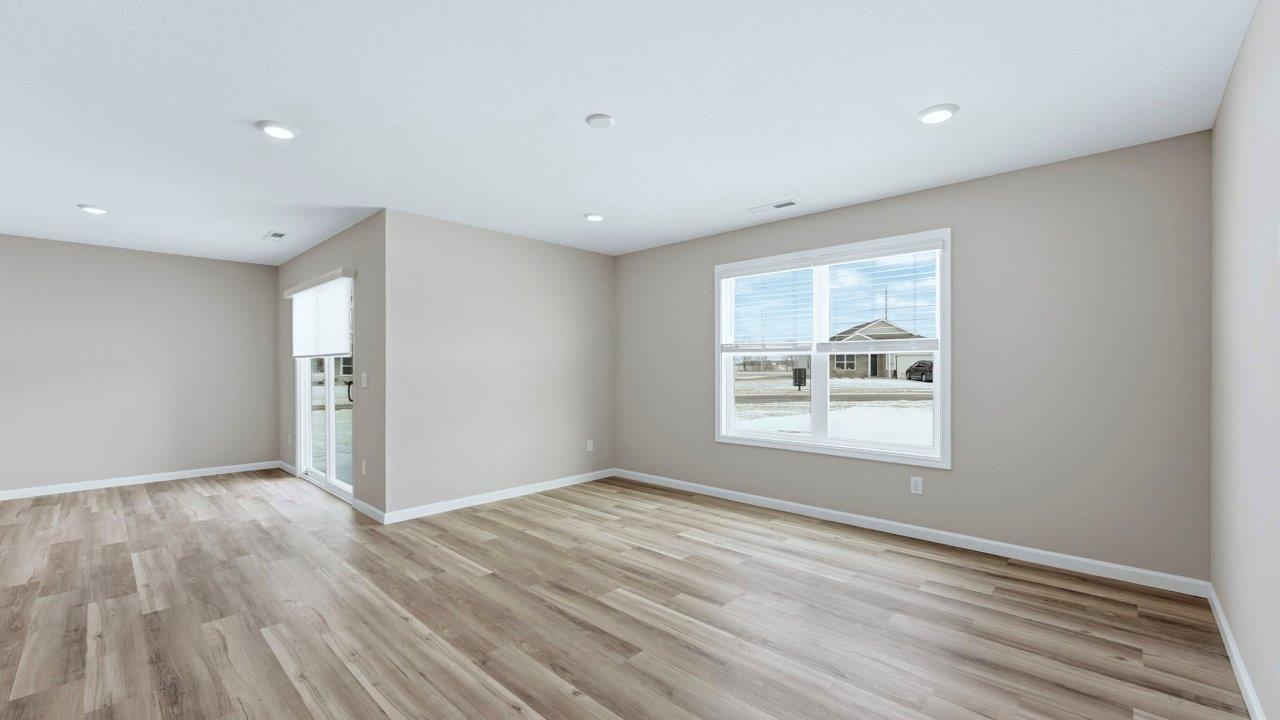 living room with lvp flooring, popular grey walls, 2 windows