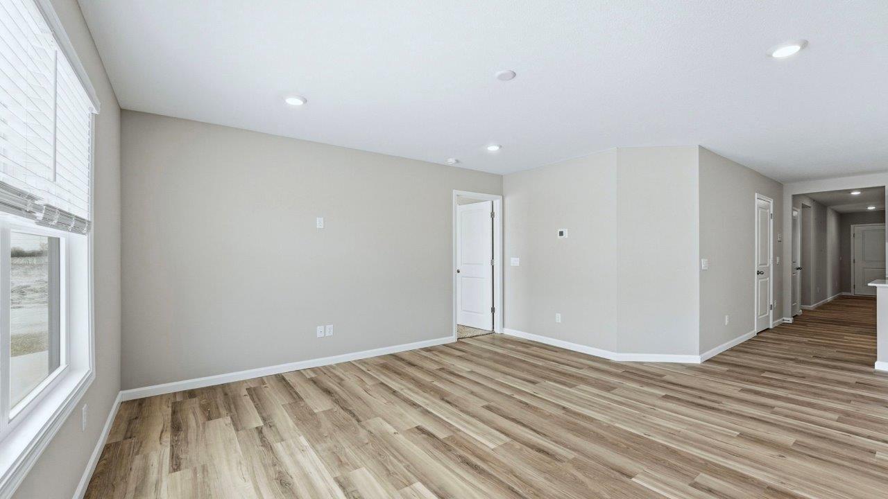 living room with lvp flooring, popular grey walls, 2 windows