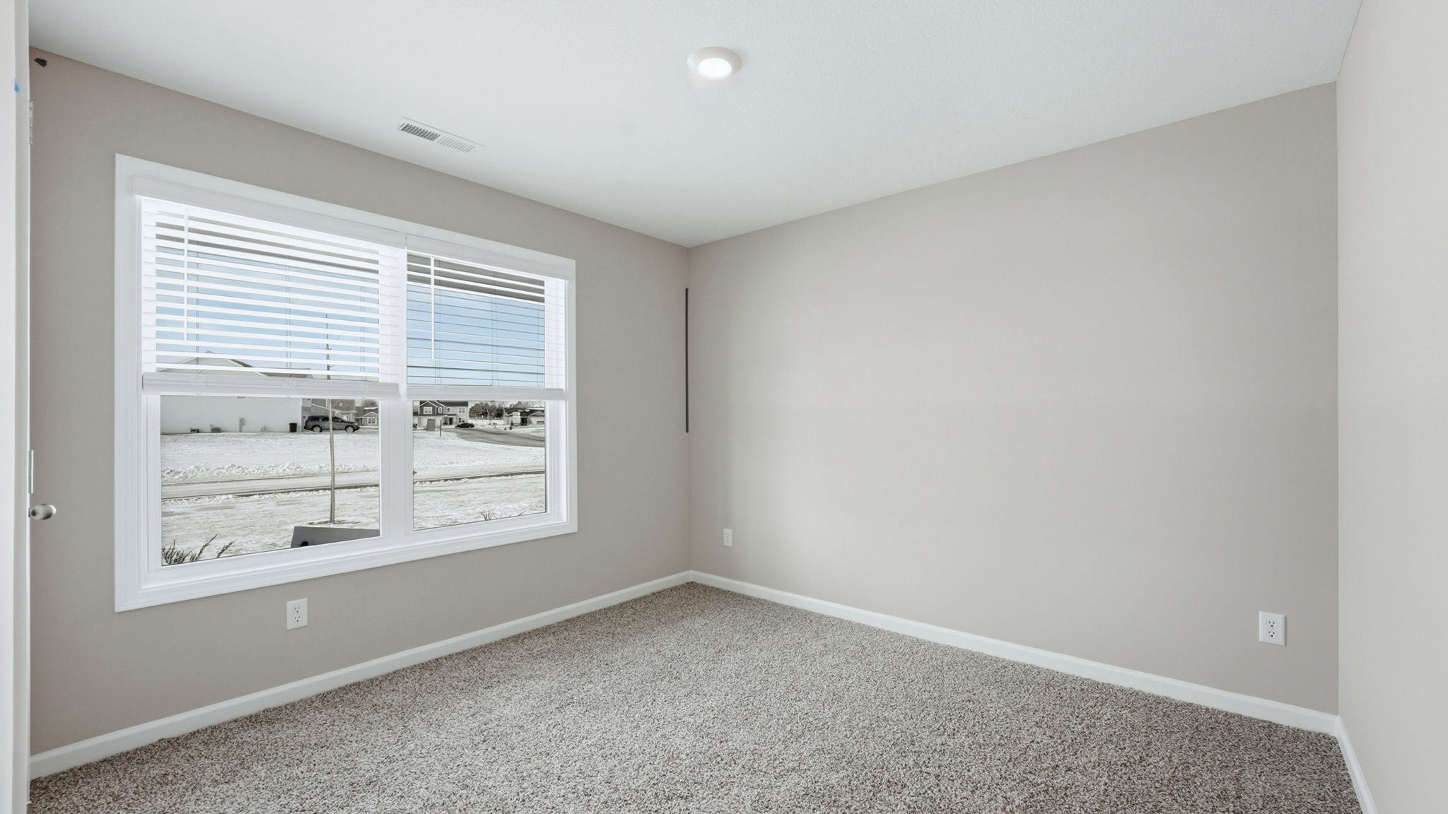 bedroom 2 with carpet flooring, popular gray walls, 2 windows, and closet