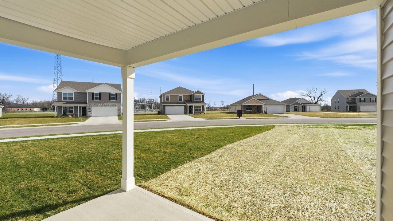 rear exterior with covered patio and large backyard