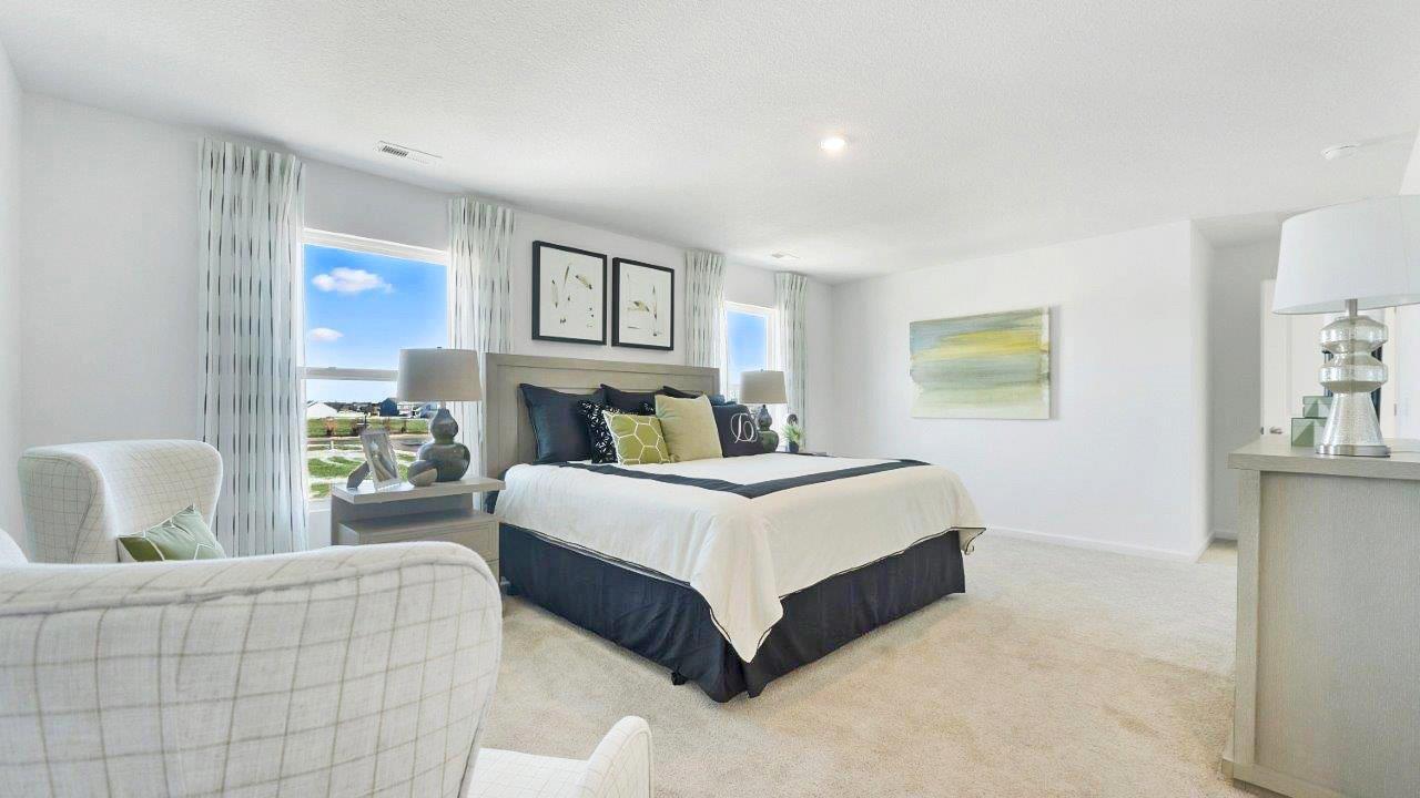 bellamy primary bedroom with carpet and ensuite bath and walk-in closet