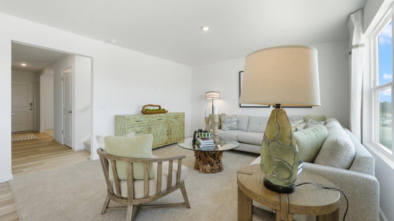 bellamy living room with open concept plan and carpet flooring