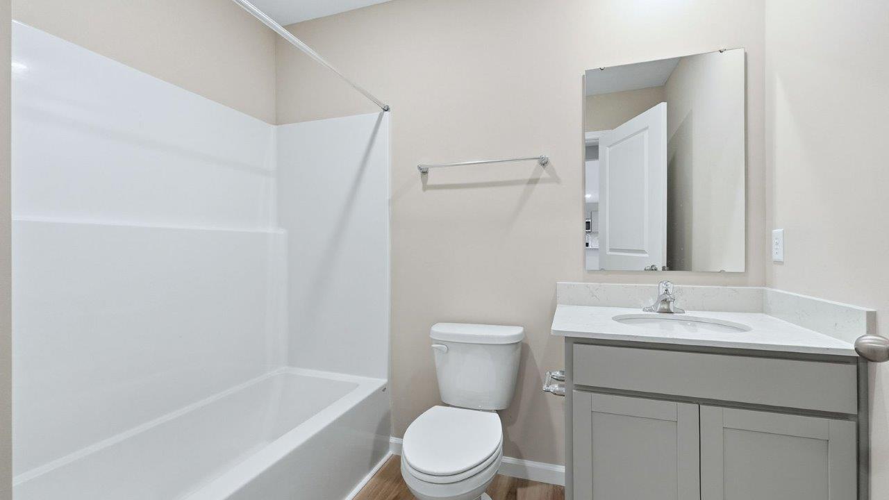 full bathroom near guest bedroom with tub shower
