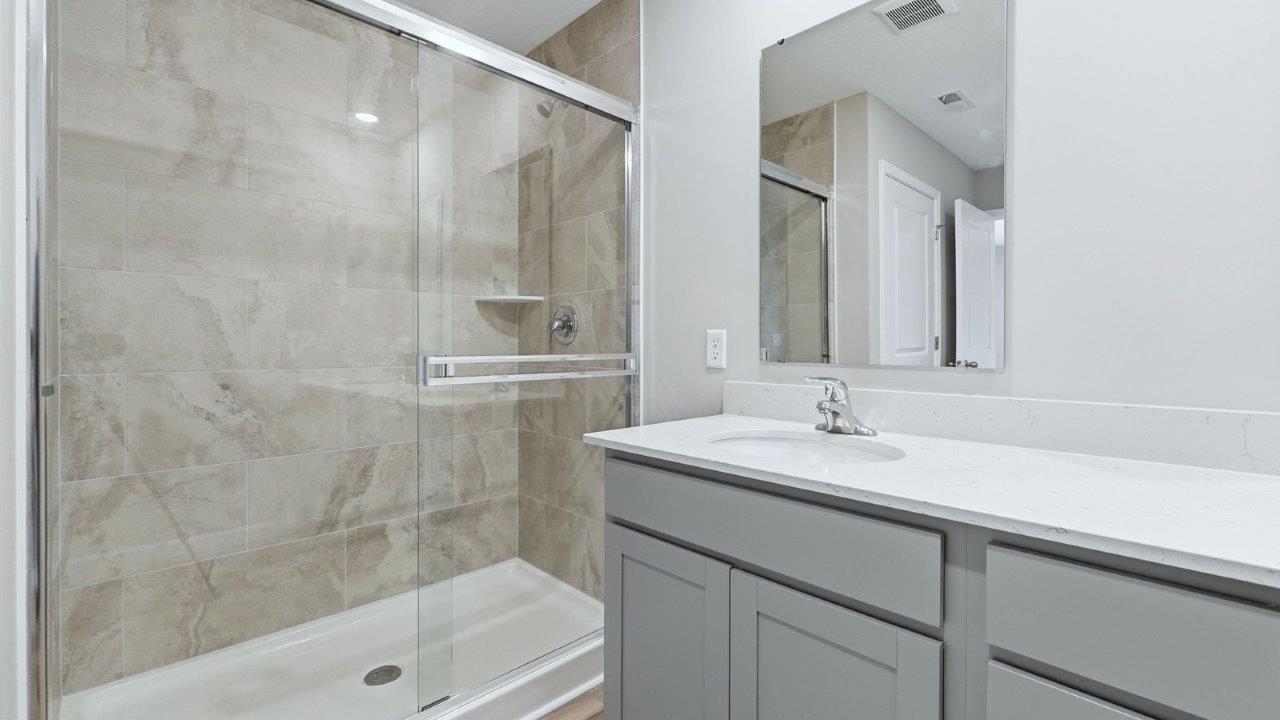 primary bedroom ensuite bathroom with dual sinks, walk-in shower, linen closet, and private water room