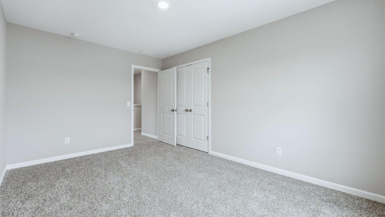 bedroom 2 with carpet flooring, closet, and 1 window