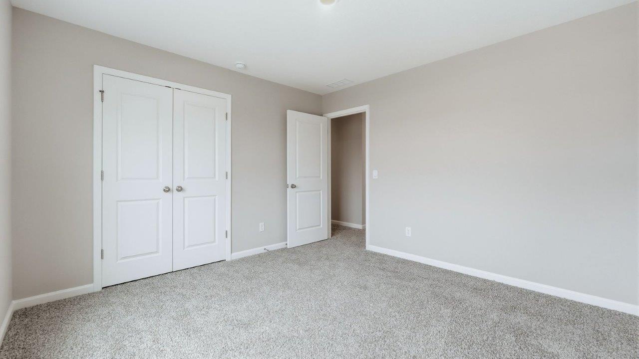 bedroom 3 with carpet, 2 windows, and closet