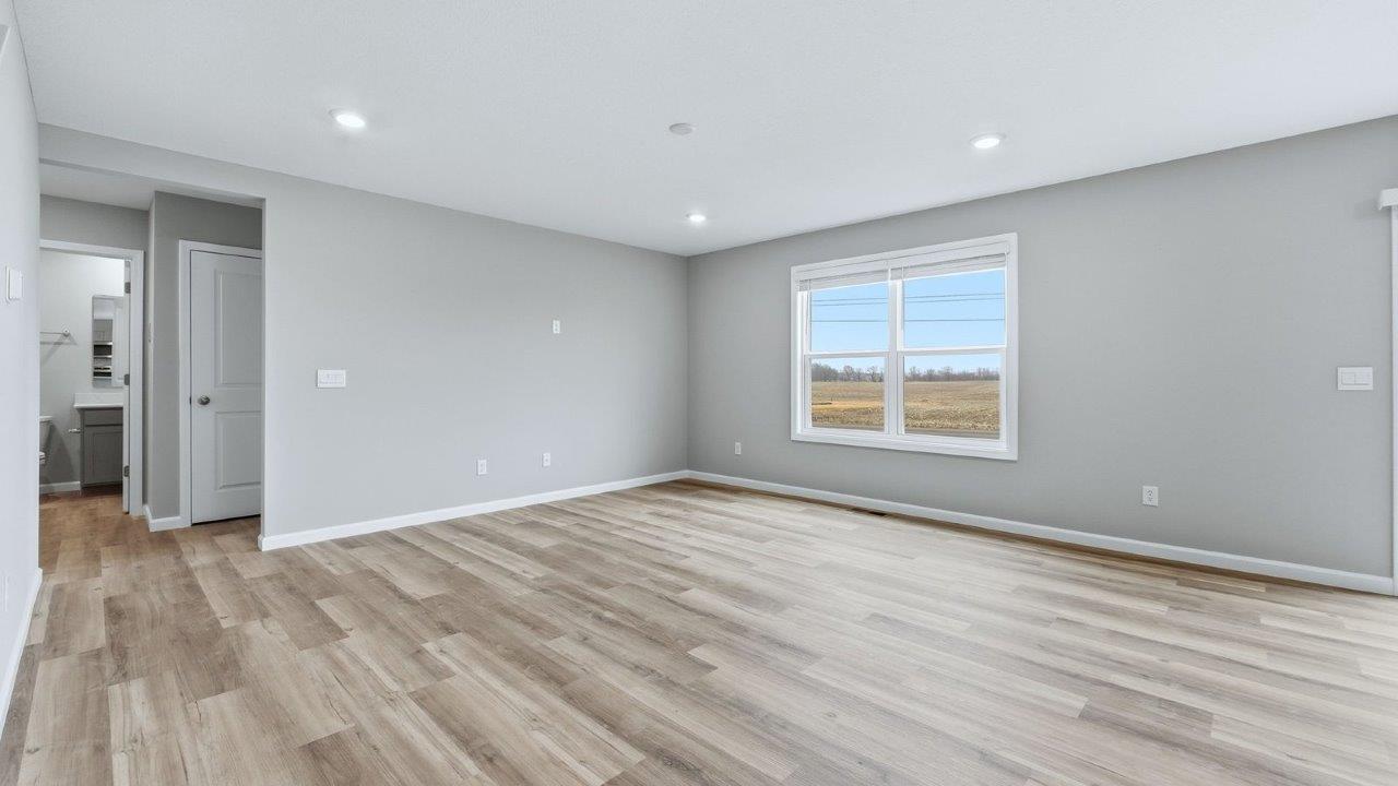open layout living room with mohawk avery lvp, popular grey walls, and large windows