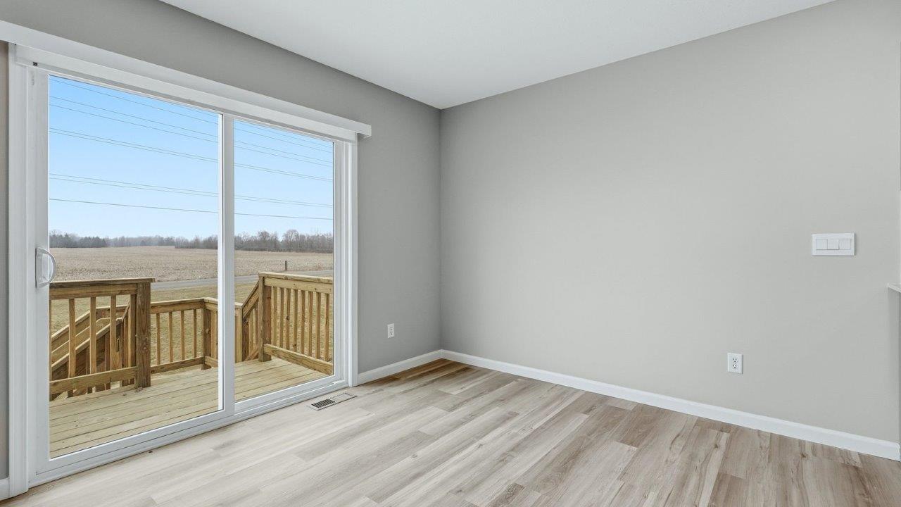 dining space with lvp flooring and sliding door to backyard deck