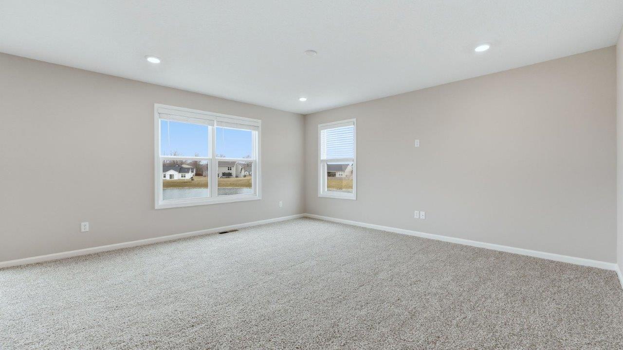 living room with carpet flooring, 3 windows, and open layout