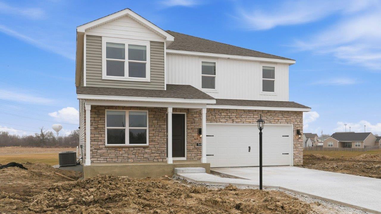 stamford exterior with 2 car garage, covered front porch, white shake, white board and batton, flagstone siding, and colorado stone