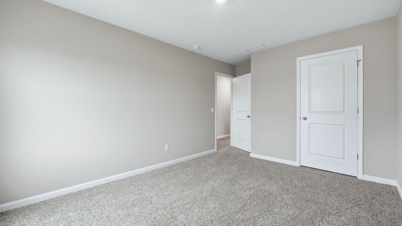 bedroom 2 with 1 window, beige carpet, and closet
