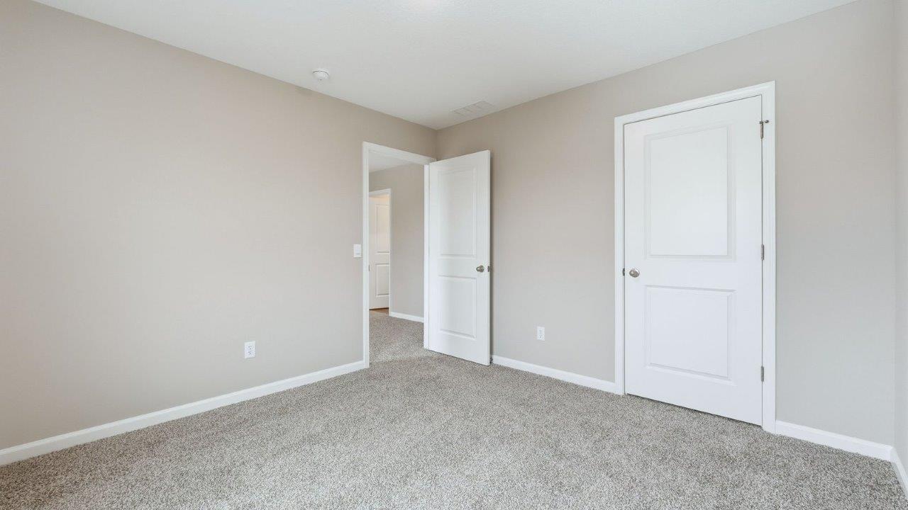 bedroom 3 with 1 window, beige carpet, and closet