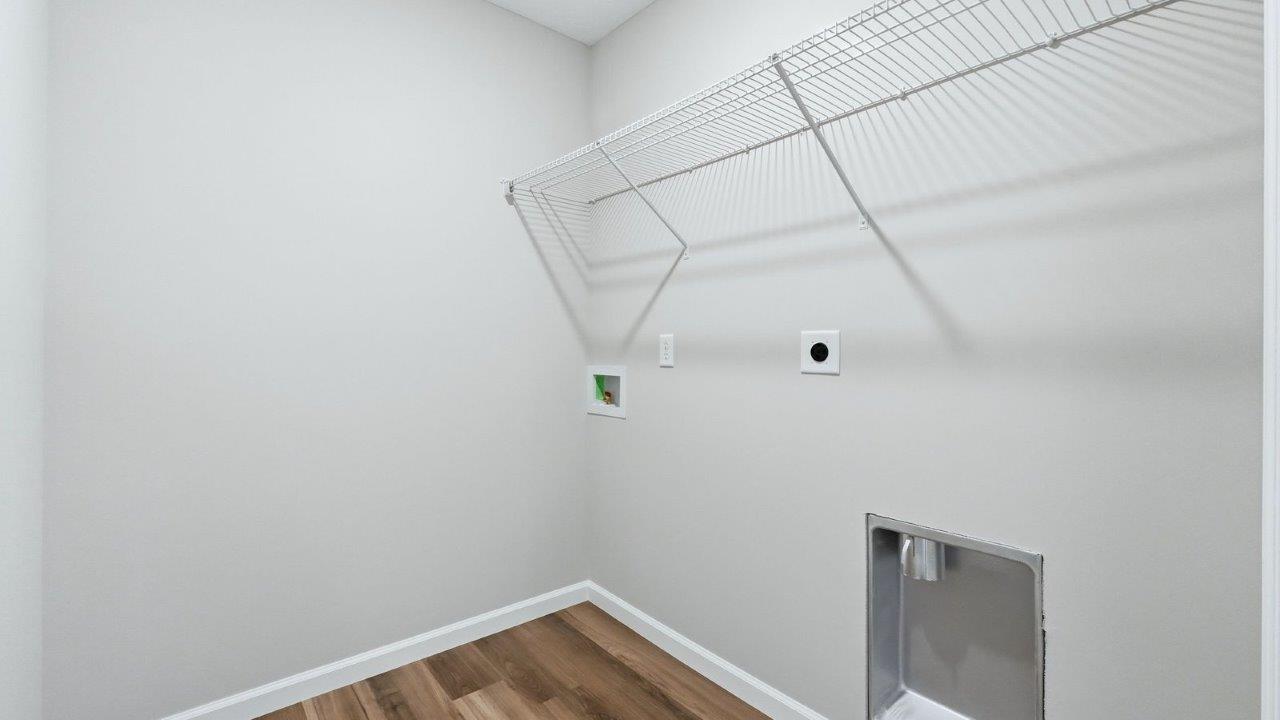 laundry room with lvp, hookups, and shelf