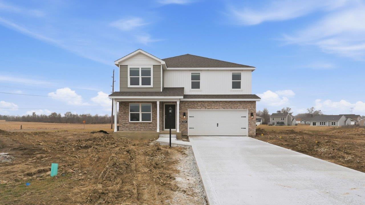 stamford exterior with 2 car garage, covered front porch, white shake, white board and batton, flagstone siding, and colorado stone