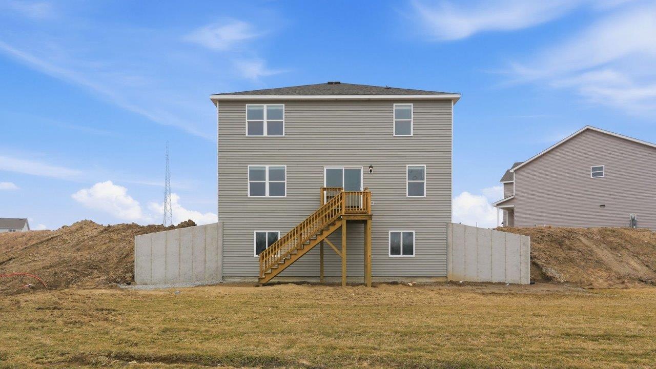 rear exterior with spacious yard and deck