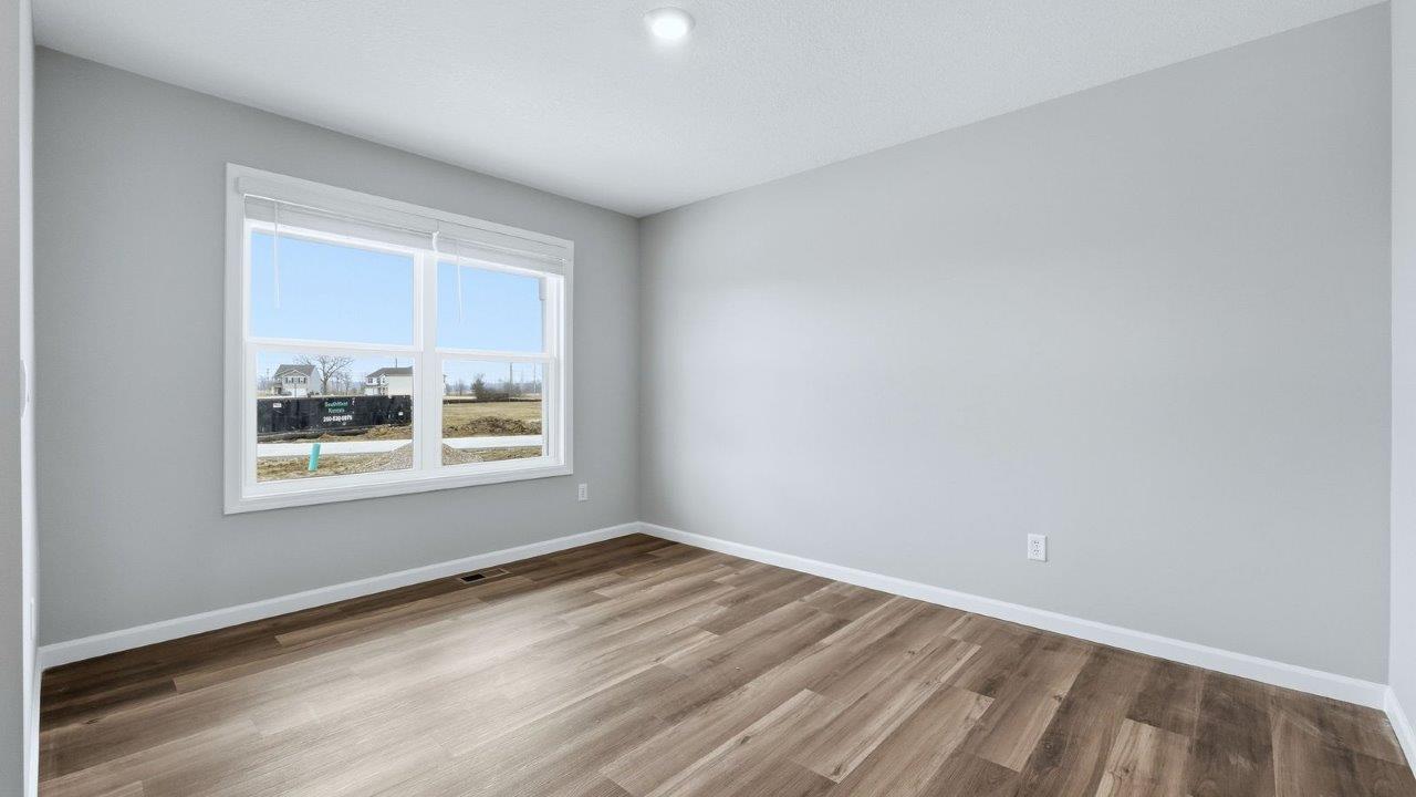 front of home study with mohawk eastmont lvp, 2 windows, and popular grey walls