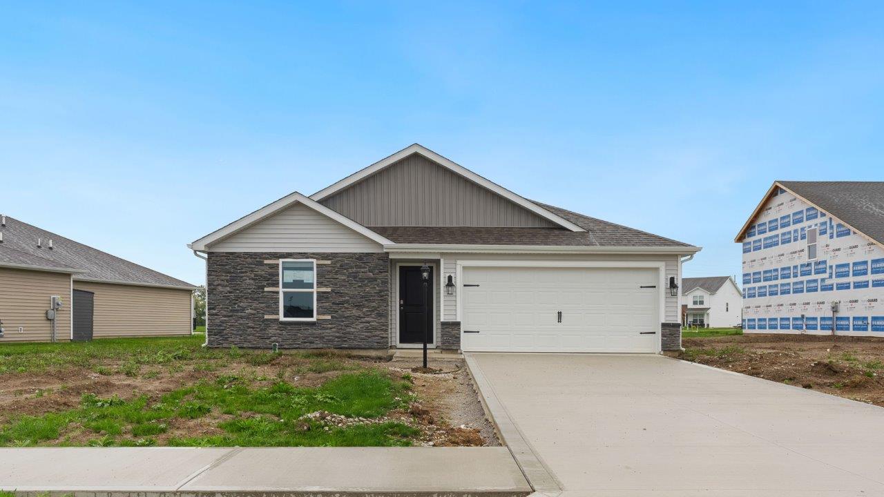 fawn creek estates freeport - exterior with 2 car garage, yard to be sodded and landscaped, and stone facade