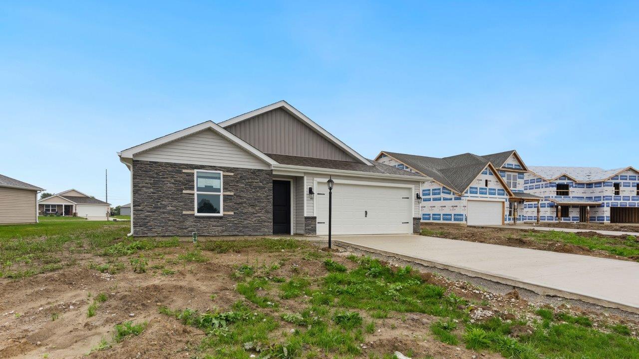 fawn creek estates freeport - exterior with 2 car garage, yard to be sodded and landscaped, and stone facade