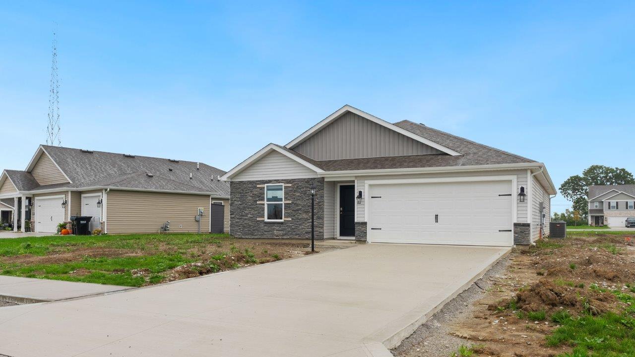 fawn creek estates freeport - exterior with 2 car garage, yard to be sodded and landscaped, and stone facade