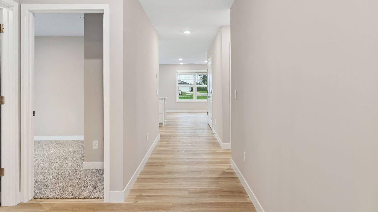 fawn creek estates freeport - front door and foyer with lvp flooring leading into open layout living room