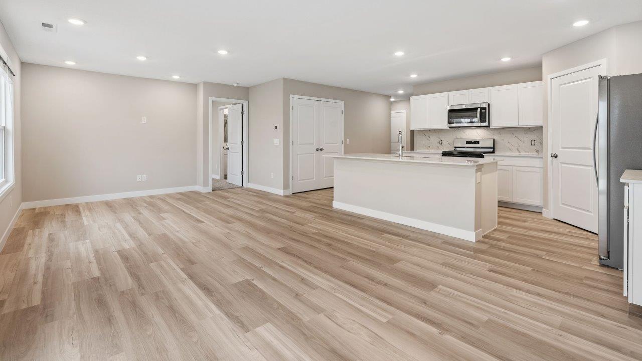 fawn creek estates freeport - causal dining room with lvp flooring and sliding glass door to backyard