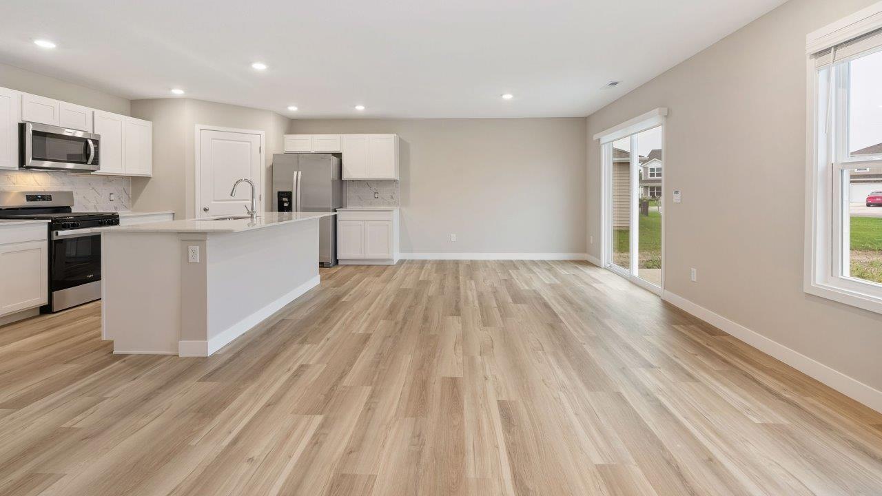 fawn creek estates freeport - causal dining room with lvp flooring and sliding glass door to backyard