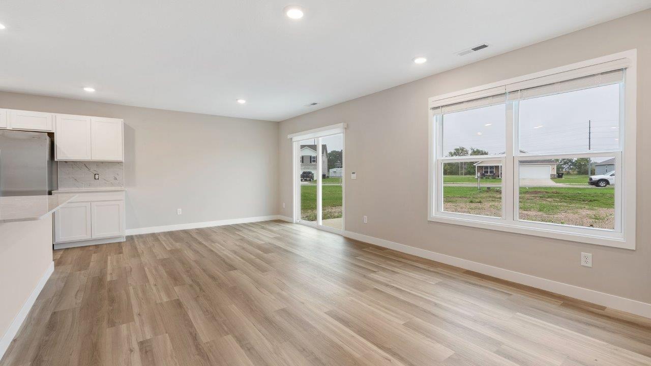 fawn creek estates freeport - causal dining room with lvp flooring and sliding glass door to backyard