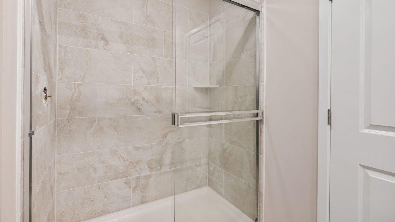 fawn creek estates freeport - primary bedroom ensuite bathroom with dual sink vanity and tile walk in shower