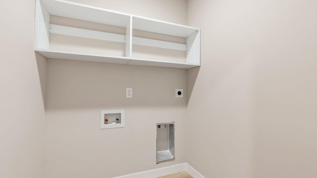 fawn creek estates freeport - laundry room with built in shelf, lvp flooring, and hookups