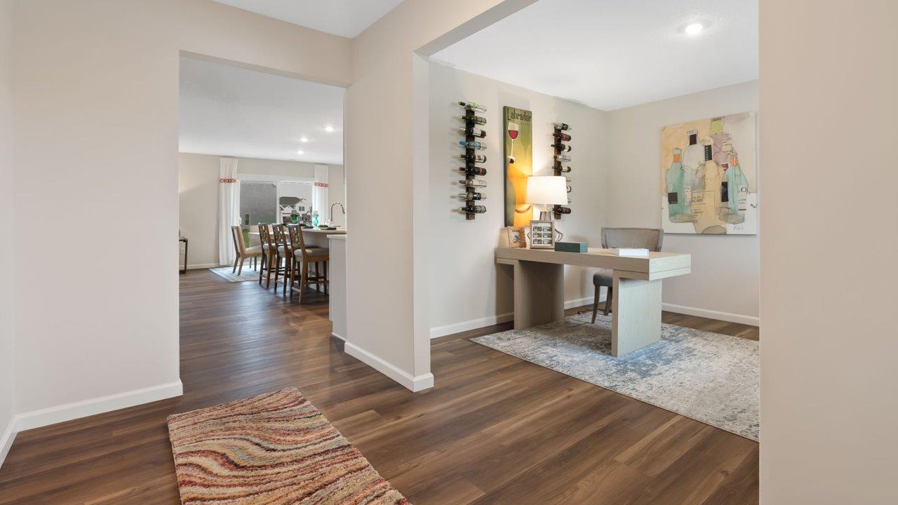 farmstead at carroll creek henley model home interior front door and foyer with mohawk eastmont lvp flooring leading into study and living room