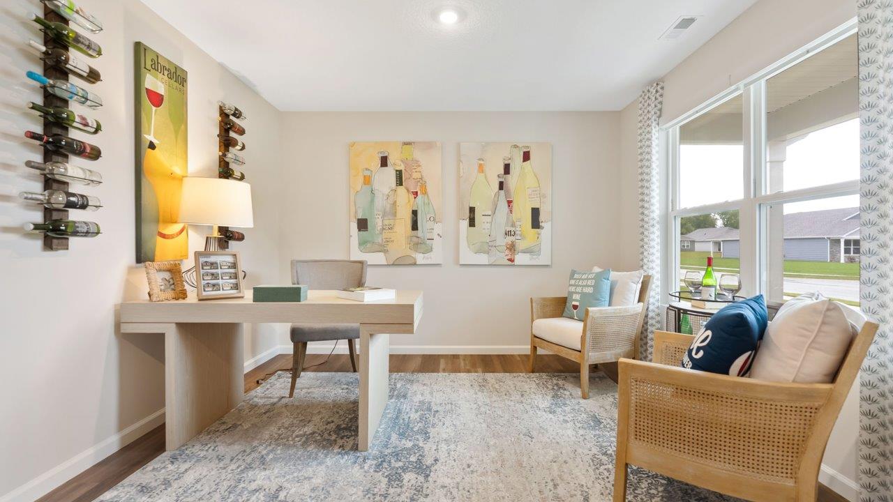 farmstead at carroll creek henley model home study at front of home with lvp flooring, 2 windows, and heron plume painted walls