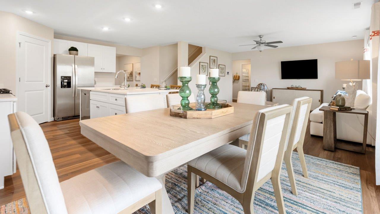 farmstead at carroll creek henley model home casual dining room with lvp flooring and sliding glass door leading to backyard and patio