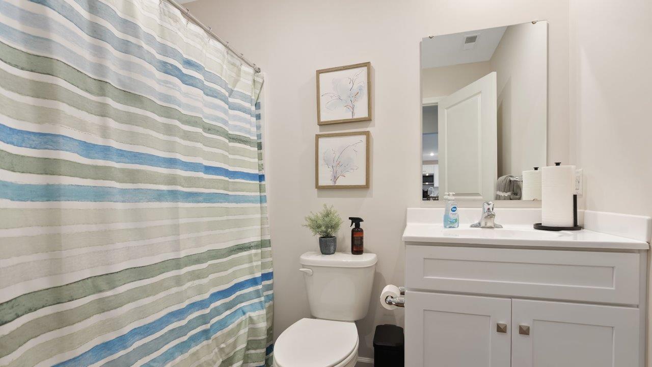 farmstead at carroll creek henley model home first floor guest bathroom with tub shower and single vanity sink