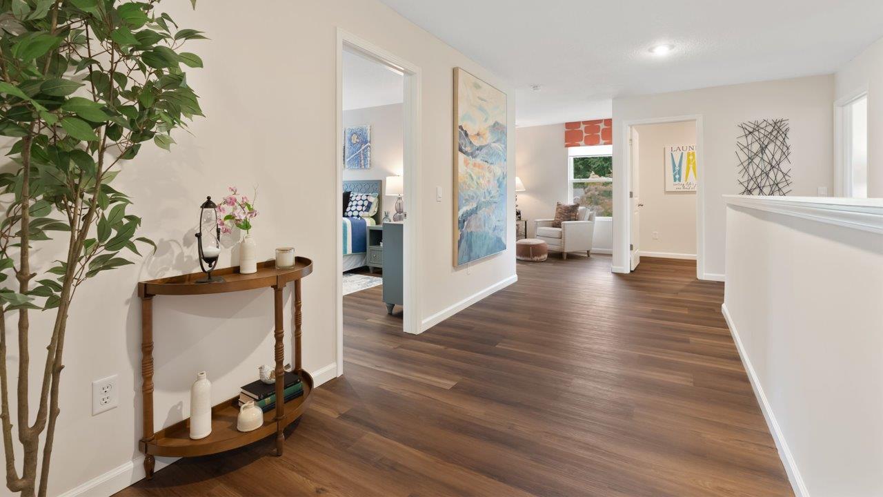farmstead at carroll creek henley model home second floor stair landing and spacious hallway with lvp flooring