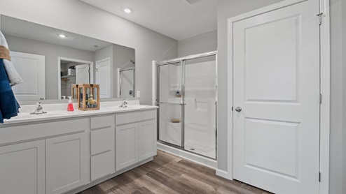 sonora chatham model home Bathroom off of main bedroom with dual vanity sinks and walk in shower