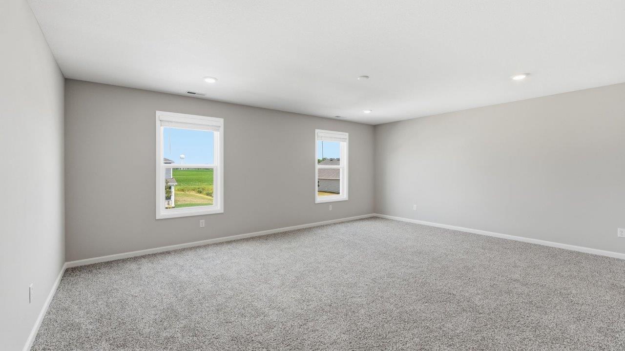 sonora elm primary bedroom with carpet flooring popular grey walls and ensuite full bathroom and walk in closet
