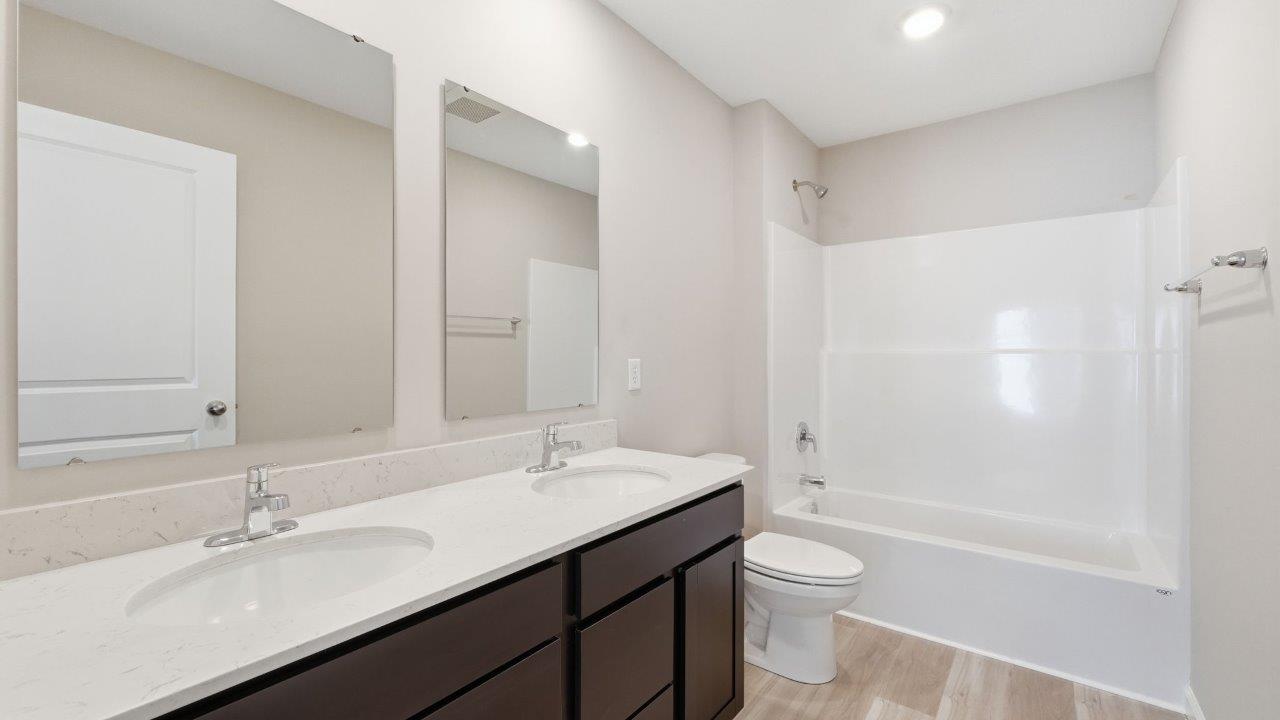 sonora elm full bathroom with dual sinks and tub shower