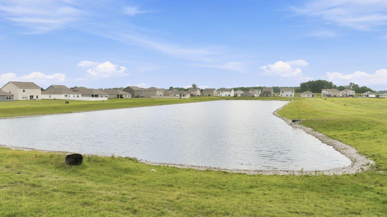 sonora elm backyard with concrete patio with pond view