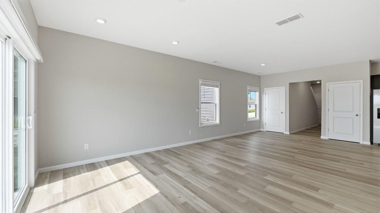 sonora elm open concept living room with sliding glass door to backyard and lvp flooring