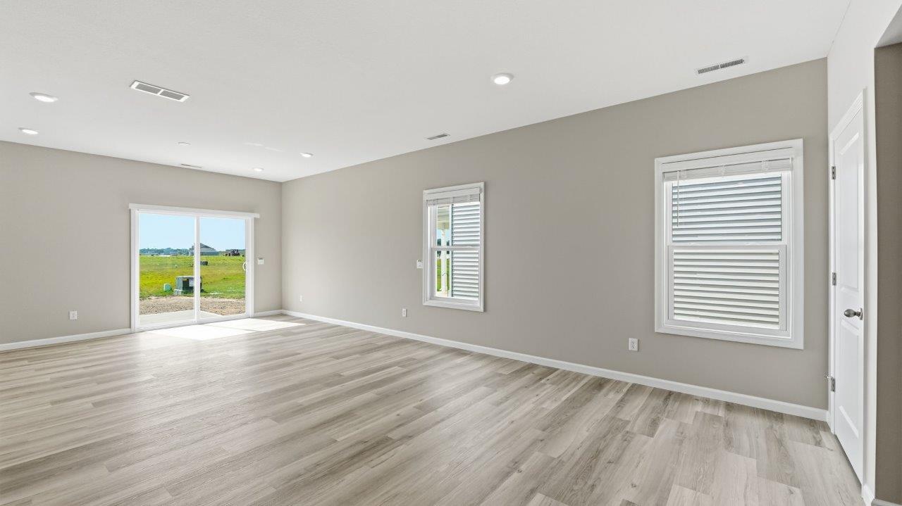 sonora elm open concept living room with sliding glass door to backyard and lvp flooring