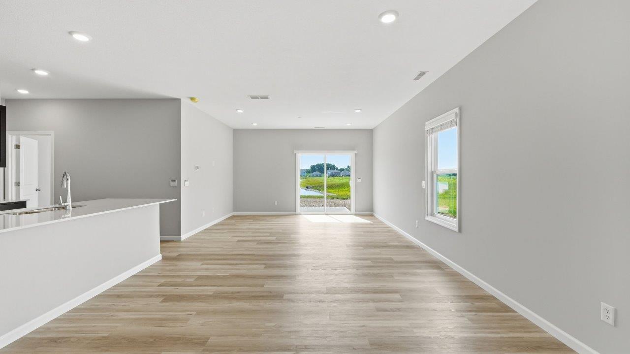 sonora elm open concept living room with sliding glass door to backyard and lvp flooring