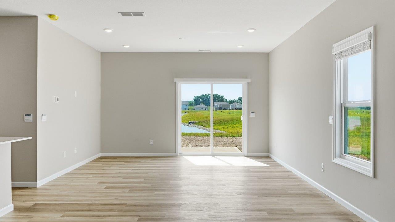 sonora elm open concept living room with sliding glass door to backyard and lvp flooring