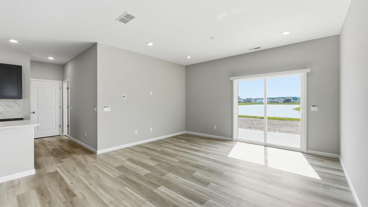 sonora elm open concept living room with sliding glass door to backyard and lvp flooring