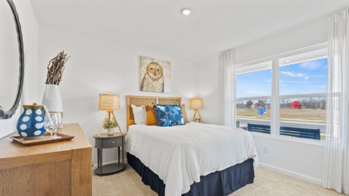 Chatham model bedroom 3 with 2 large windows and carpet flooring