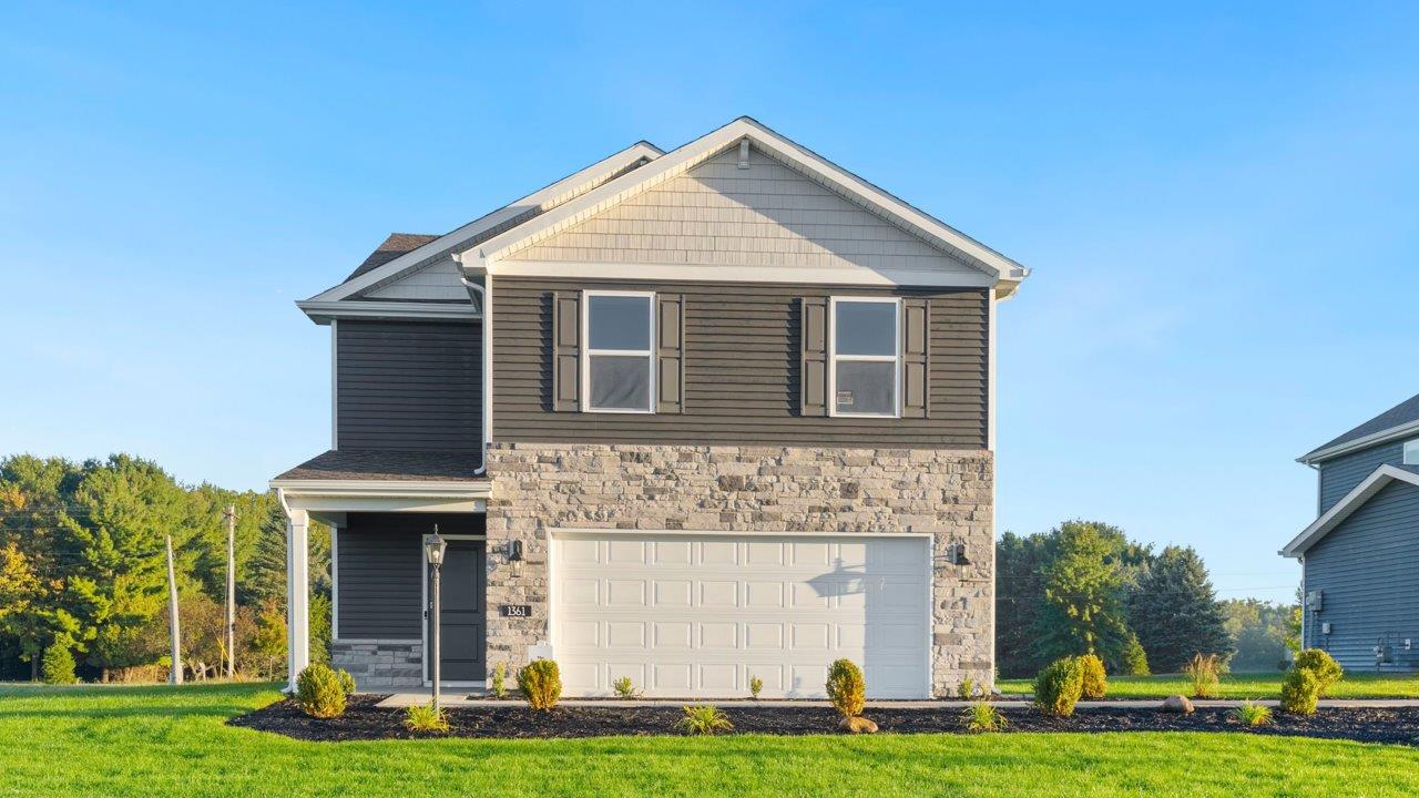 Greenbrier Pine Model Home - exterior with ironstone  vinyl siding, tuesdeo grey shutters, sterling shake, and weathered edge manistee stone
