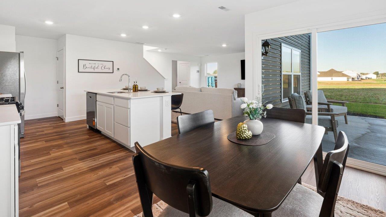 Greenbrier Pine Model Home - casual dining room with mohawk eastmont lvp flooring and sliding glass door to backyard