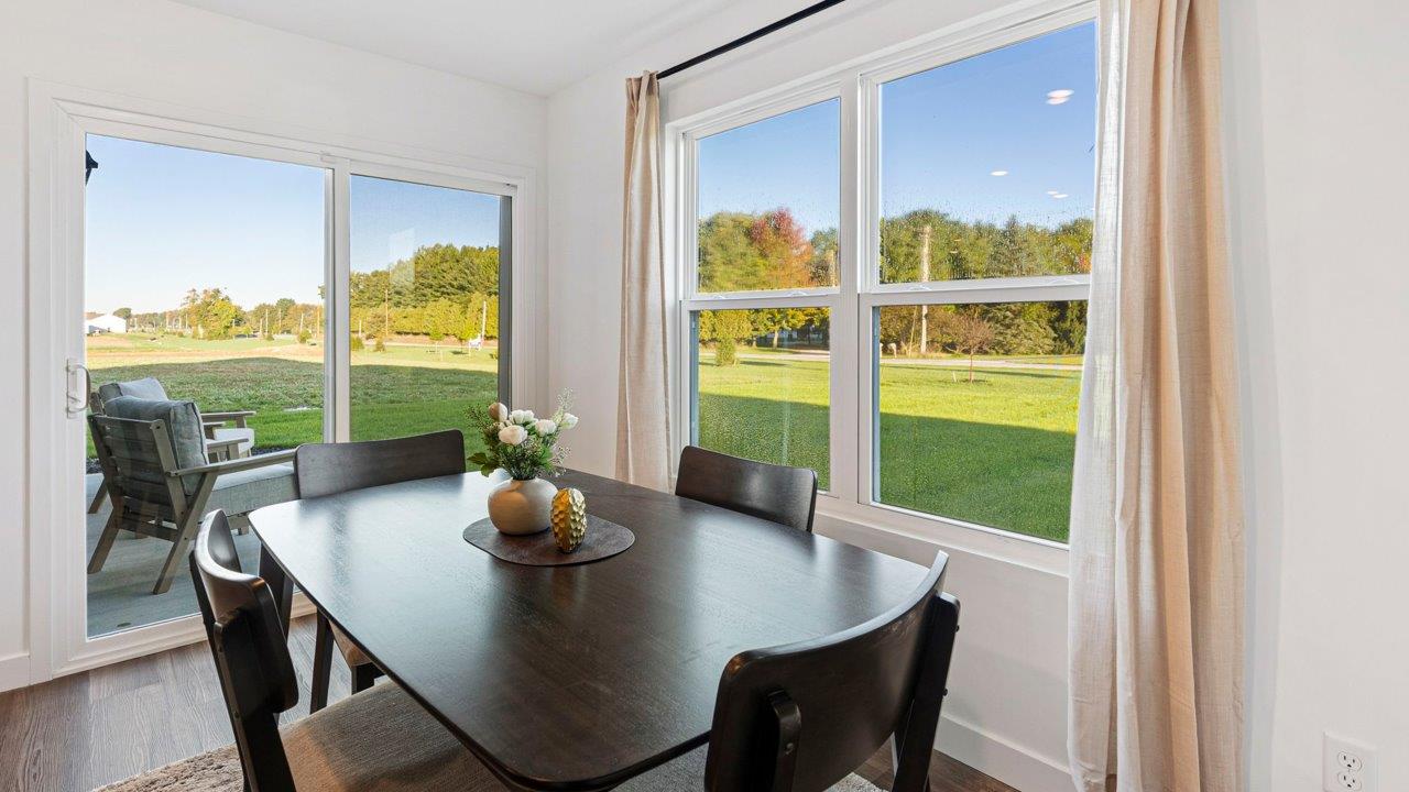 Greenbrier Pine Model Home - casual dining room with mohawk eastmont lvp flooring and sliding glass door to backyard