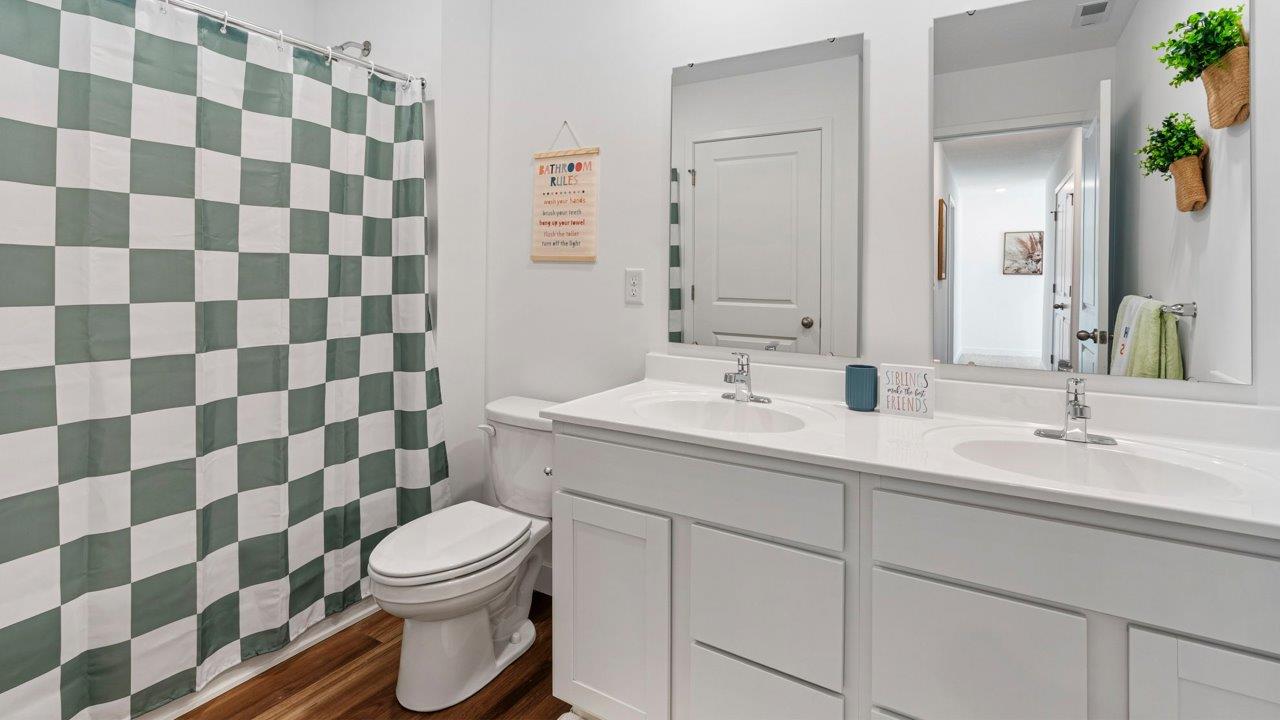 Greenbrier Pine Model Home -  full bathroom with dual sink vanity and tub shower