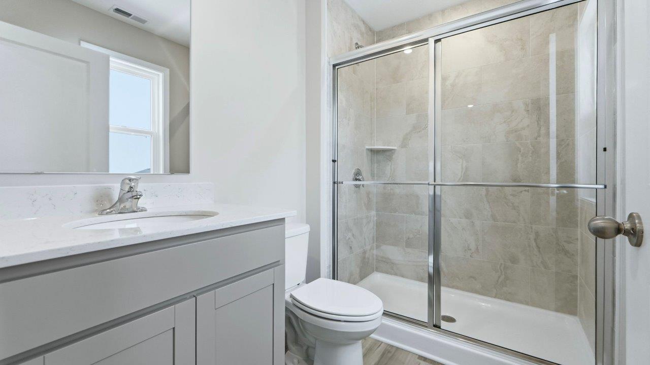 primary ensuite bath with tile walk in shower